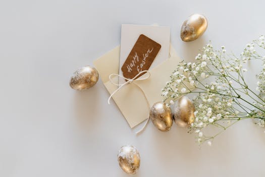 Top view of a sophisticated Easter greeting card with golden eggs and delicate flowers for a festive celebration.