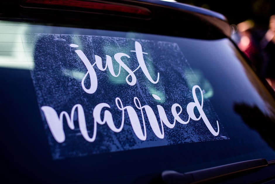 Wedding decoration with a 'just married' sign on a car's rear window, symbolizing celebration and union.