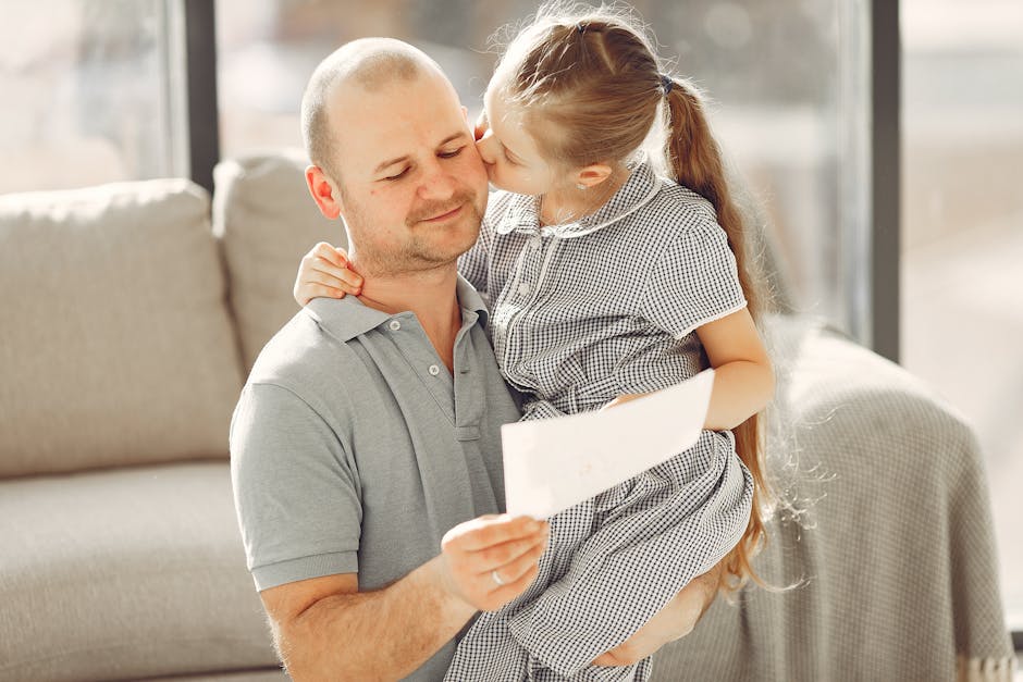 A father and daughter share a tender moment indoors, filled with love and happiness.