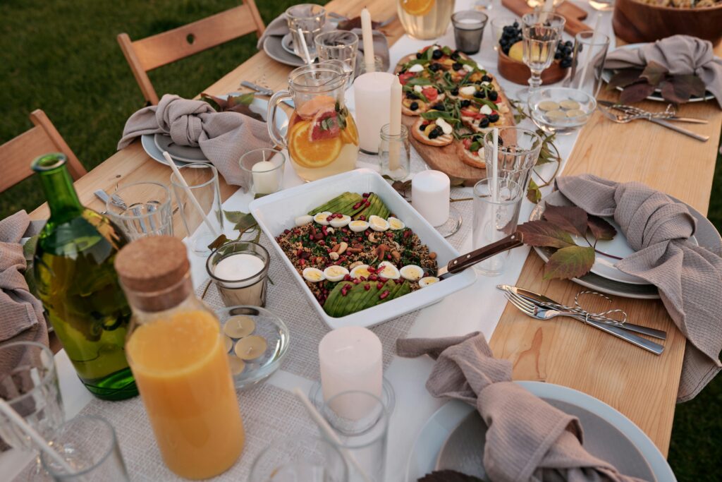 Beautiful outdoor dinner table with delicious food and elegant setting for a summer evening gathering.