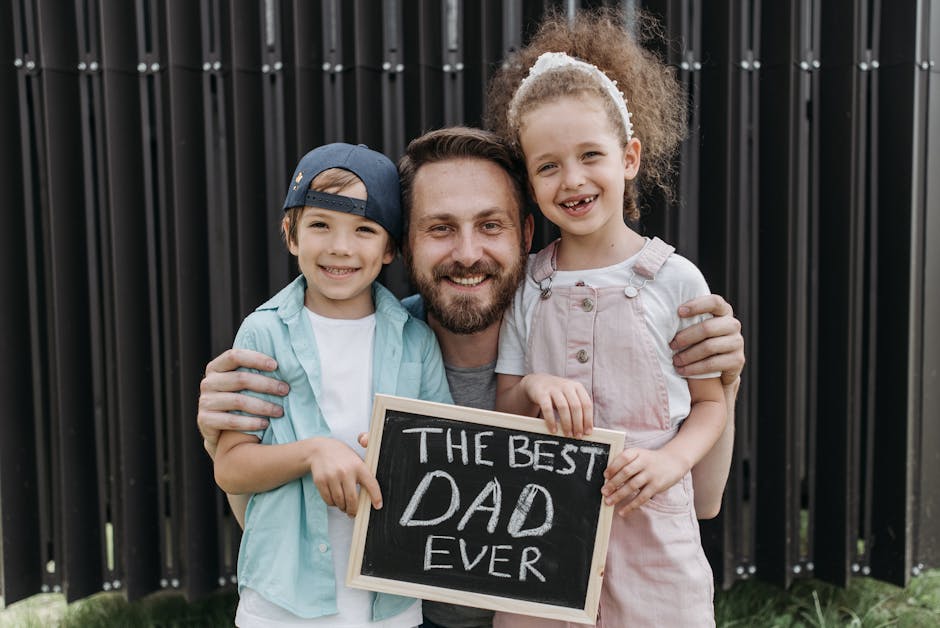 pexels-photo-8763193-8763193 A joyful father hugging his children with a "Best Dad Ever" sign.